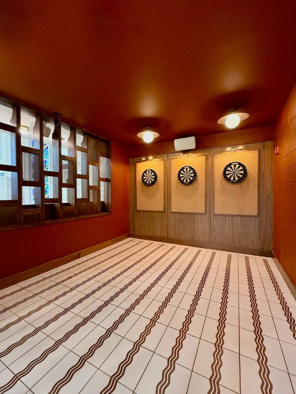 Retro tile flooring in dart lounge area inside renovated Church of Pickleball facility in Chicago IL